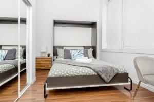 a bedroom with a bed and a mirror at Great Kensington Market 2BR Apartment in Toronto
