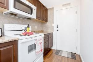 a kitchen with a white stove top oven next to a door at Great Kensington Market 2BR Apartment in Toronto