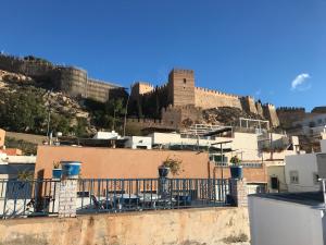 a view of a city with a castle in the background at Casita bonita de pescador parking y sabanas en opción in Almería