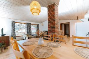 a kitchen and dining room with a table and chairs at Hjelmeland Camping & Hostel Nøkling in Hjelmeland
