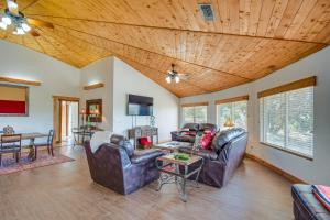 a living room with leather furniture and a wooden ceiling at Canyon Rim Retreat with Private Yard and Hot Tub! in Amarillo