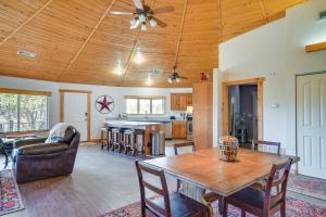 a dining room and living room with a wooden ceiling at Canyon Rim Retreat with Private Yard and Hot Tub! in Amarillo
