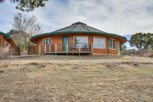 a house with a large porch in a field at Canyon Rim Retreat with Private Yard and Hot Tub! in Amarillo