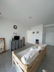 ein großes Bett in einem Zimmer mit einer Uhr an der Wand in der Unterkunft departamento céntrico y moderno in Gualeguaychú