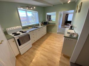 a kitchen with a stove and a sink at The cottage at the Gables in Motueka