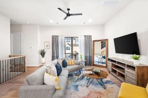 a living room with a couch and a flat screen tv at New - Home Sweet Houston in Houston