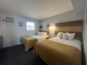 a hotel room with two beds and a window at Granada Ocean Resort in Wildwood Crest