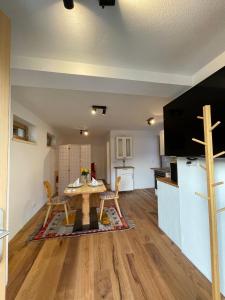 a living room with a table and a kitchen at Latina II in Westendorf