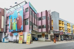 a building with a large billboard on the side of it at Thangam Lodge in Coimbatore