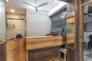 a kitchen with a counter in a room at Thangam Lodge in Coimbatore