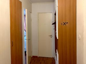 a hallway with a white door and a room at City Antti majoitus in Kokkola +17 photos