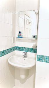 a bathroom with a sink and a mirror at The Crows Nest in Eyemouth +19 photos