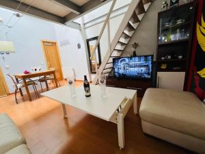 a living room with a white table with bottles on it at Palafox in Madrid