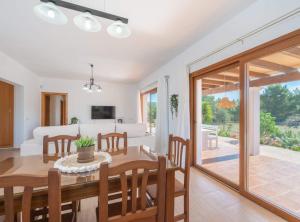 a dining room and living room with a table and chairs at Villa Sa Planeta in Sant Josep de Sa Talaia