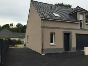 a house with a parking lot with a garage at Villa Pétale de Rose à Merlimont in Merlimont