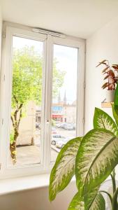 a window in a room with a plant at Votre Escale - Magellan Cinéma in Niort