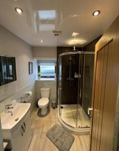 a bathroom with a shower and a toilet and a sink at 5 Riverside Place Thurso. 2 bed, 2 bathrooms. in Thurso