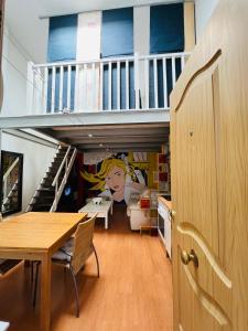 a room with a staircase with a table and a dining room at Palafox in Madrid