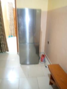 a stainless steel refrigerator in the corner of a room at ROYAL HOUSE INTERNATIONAL in Porto-Novo