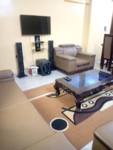 a living room with a couch and a coffee table at ROYAL HOUSE INTERNATIONAL in Porto-Novo