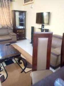 a living room with a couch and a table at ROYAL HOUSE INTERNATIONAL in Porto-Novo