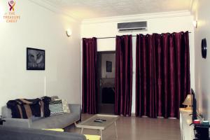 a living room with red curtains and a couch at Two Bedroom Villa at Ouagadougou in Ouagadougou