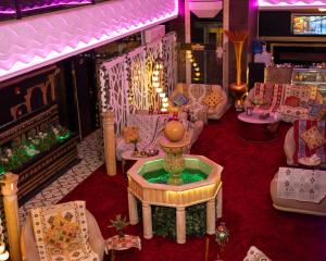 a room with couches and a table with a bowl at Sama Paris Plaza Hotel in Amman