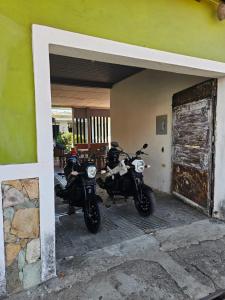 two motorcycles parked outside of a building at Casa 25 hostal in Santa Ana