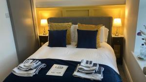 a hotel room with a bed with utensils on it at Lisheen Lodge in Galway