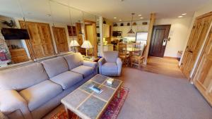 a living room with a couch and a table at Manor Vail Lodge in Vail
