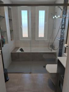 a bathroom with a shower and a tub and a sink at Suite Poblamar in Pobla de Montornés