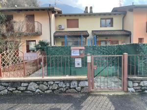 a fence in front of a house at Twentyone Holiday Home in Pisogne