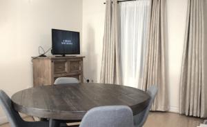 a dining room table with chairs and a television on top at Spacious 2BR flat in Central London near Elephant and Castle station in London