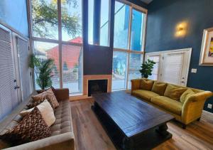 a living room with a couch and a coffee table at Montrose Oasis Pool & Hot Tub in Houston
