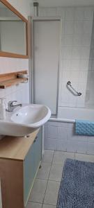 a bathroom with a sink and a bath tub at Ferienhaus Rosenthal in Anjum