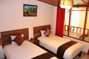 Postel nebo postele na pokoji v ubytování Inti Pacha Palace Machupicchu