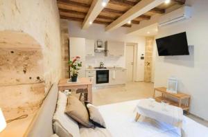 a living room with a couch and a tv at Urban Flat Garibaldi - TimeSRL Apartments in Bari