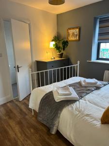 a bedroom with a bed with two towels on it at Woodquay Mews in Galway