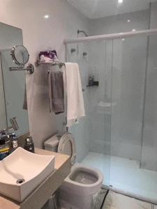 a bathroom with a shower and a toilet and a sink at Alugo 1 Suite 210 no Mont Blanc in Nova Iguaçu