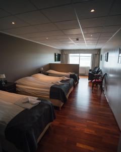a row of beds in a hotel room at Sel - Hótel Mývatn in Myvatn +92 photos