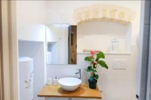 a bathroom with a white sink and a white refrigerator at Urban Flat Garibaldi - TimeSRL Apartments in Bari