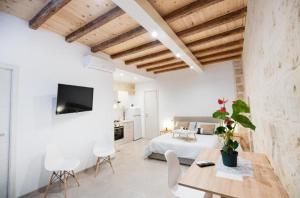 a bedroom with a bed and a table and chairs at Urban Flat Garibaldi - TimeSRL Apartments in Bari