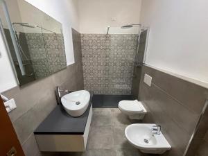 a bathroom with a sink and a toilet and a shower at Twentyone Holiday Home in Pisogne