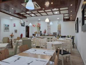 a restaurant with wooden tables and chairs and tablesearcher at Hotel SQUARE in Sertã