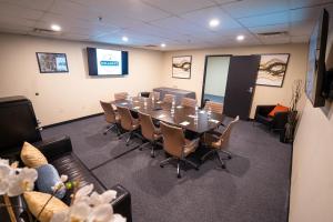 a conference room with a long table and chairs at The Delaney Hotel in Orlando