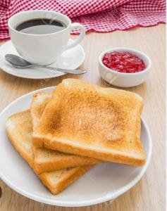 two pieces of toast on a plate with a cup of coffee at Casa Millor Vista, Rooms in Xàtiva