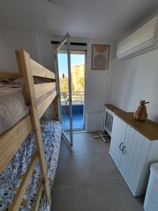 a dorm room with a bunk bed and a desk at Beautiful apartment with swimming-pool in Salou