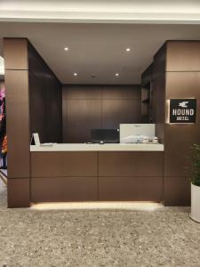 a hotel lobby with a reception desk and a sign at Hound Hotel Jeonju Deokjin in Jeonju