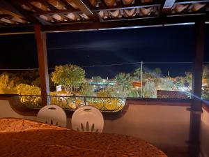 a balcony with a view of a city at night at Appartamenti Pousada Michelino in Parghelia