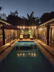 a swimming pool with lights on a house at Hostería Montes in San Ignacio